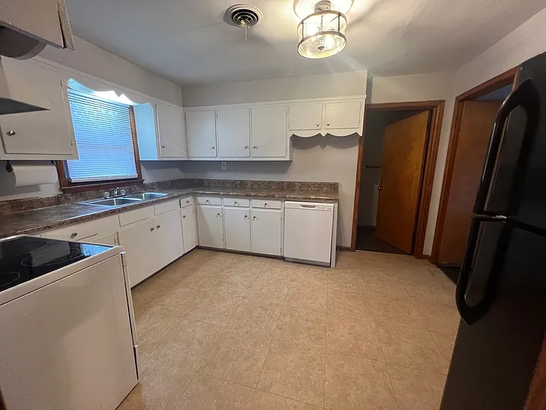 Kitchen with bathroom off of it