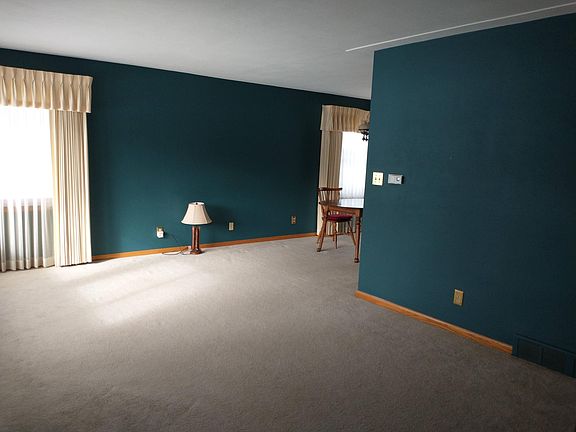 Living room - spacious and well lit with new windows - planning to update curtains to blinds