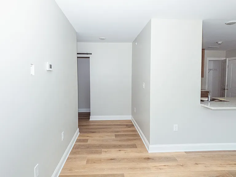 Living room view of the hallway that leads to your laundry room, bedroom , and bathroom.