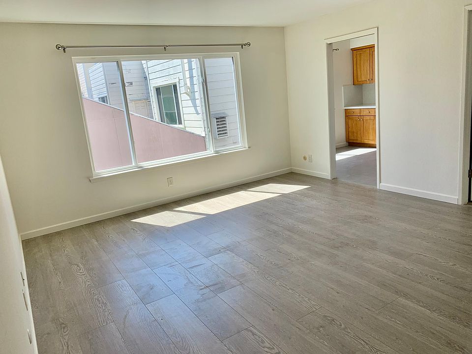 Living room facing the backyard. New double paned windows and new hardwood floors. NOTE: these photos were taken right after remodel but before the unit was cleaned.