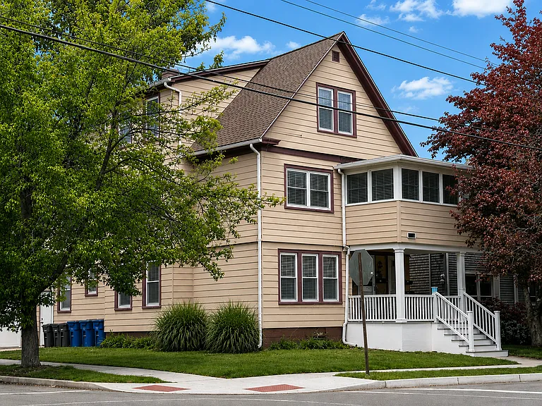 Front view of the house, with three season screened front porch