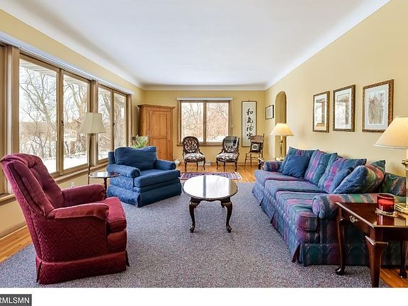 Living room with hardwood floors and coved ceiling.