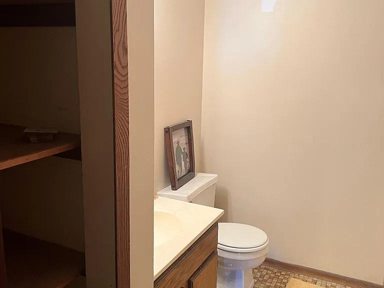 Main level half bathroom with linen closet