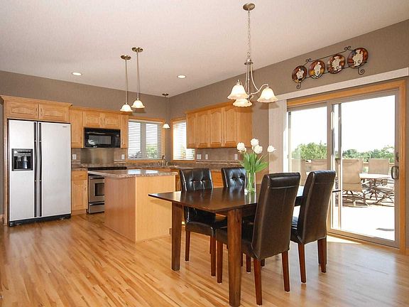 Sunny eat-in kitchen with stainless steel appliances