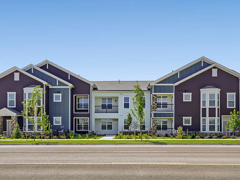 Welcome home to Garrett Harvest Junction West _ new apartments in Longmont, CO featuring craftsman-inspired architecture, stone accents, and lush landscaping right along Bountiful Ave.