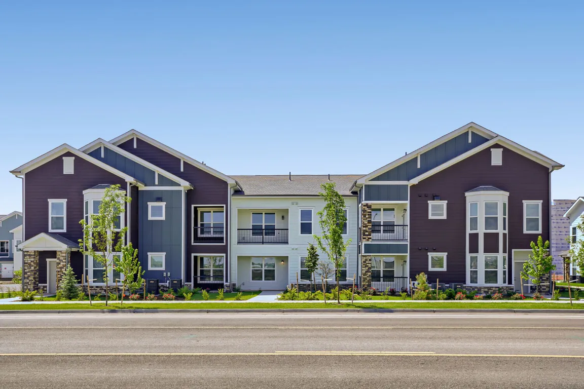 Welcome home to Garrett Harvest Junction West _ new apartments in Longmont, CO featuring craftsman-inspired architecture, stone accents, and lush landscaping right along Bountiful Ave.