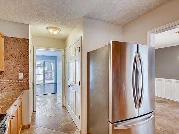 Kitchen has stainless appliances. Laundry closet with hookups is behind the closet doors. *Flooring was updated to LVP and cabinetry was painted white since this pic was taken previously*.
