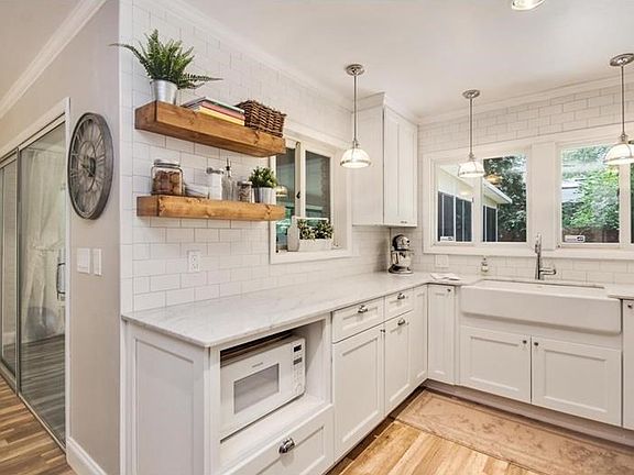 Kitchen and check out that Farmhouse Sink! Amazing Natural Light!