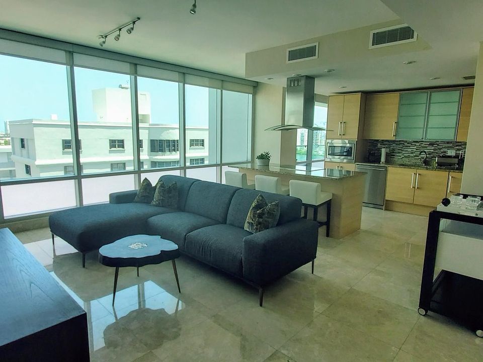 Living room with open kitchen in the background