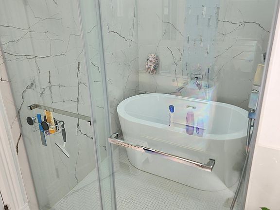 New luxury walk-in rain shower with separate bath.