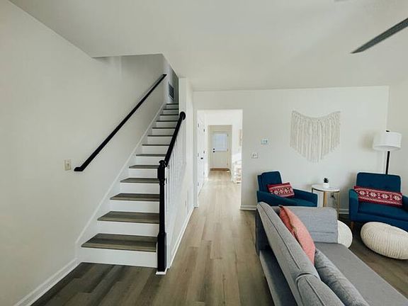 Living room to kitchen and half-bath through walk-way. Included washer/dryer just past the stairs.