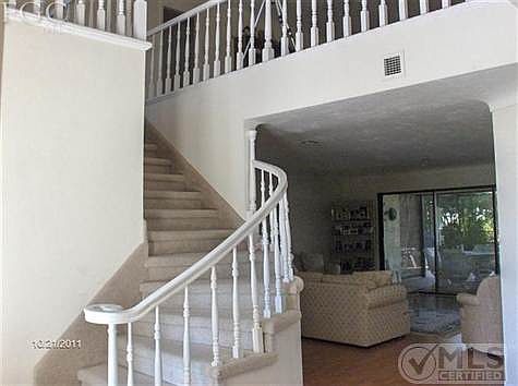 Entry stairs to loft and upstairs master suite and 2 guest bedrooms with bath and balcony over pool