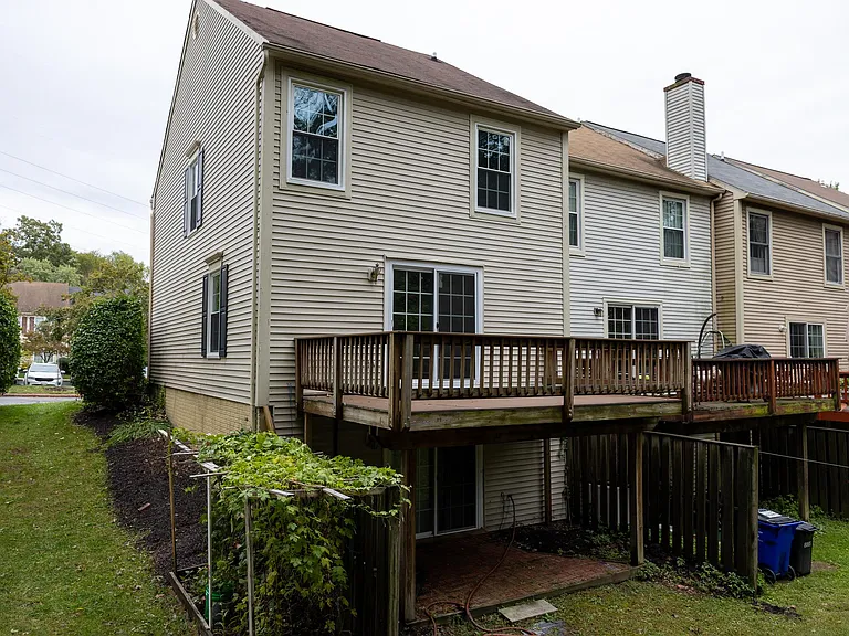 View from the back showing the deck and all out basement door to the patio.