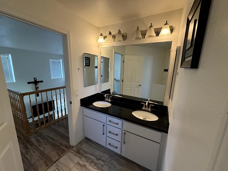 Upstairs Hall Bathroom
Dual-sink vanity with granite countertop and ample cabinet