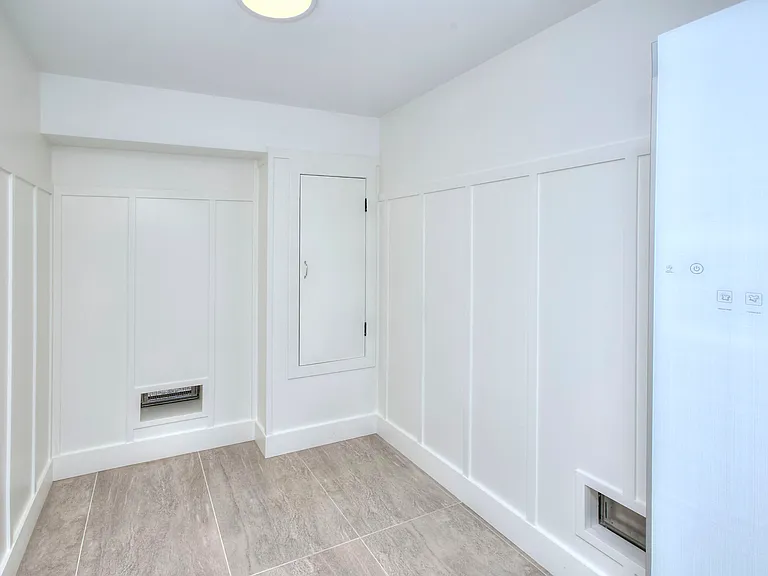 Storage room with premium dry-cleaning steam closet system. Located off of the mudroom.