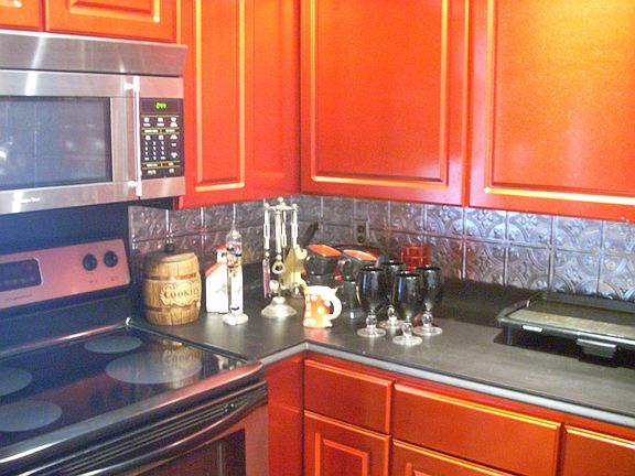 Cranberry Enameled Cabinetry with Stainless Appliances