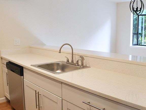 Kitchen showing breakfast bar into dining room.
