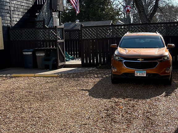 The off-street parking for Apartment A is to the left of the current tenant's car in this picture who resides in Apartment B. The patio can be accessed from a gate off the driveway.