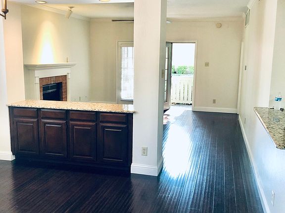 Bamboo flooring - View of dining room and living room with access to enclosed patio with gate.