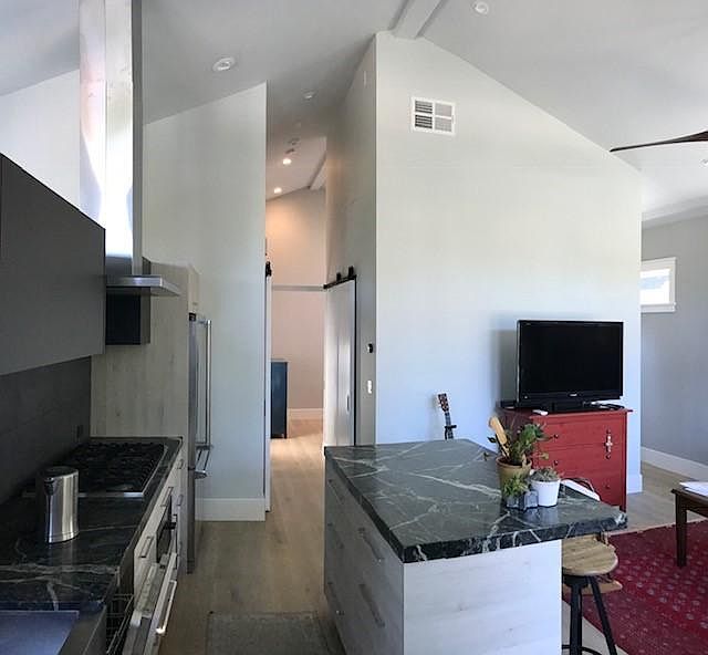 Kitchen and Living Room with Vaulted Ceiling (View from Stai
