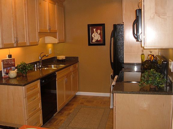 Updated kitchen with slab granite counters, maple cabinets and new appliances