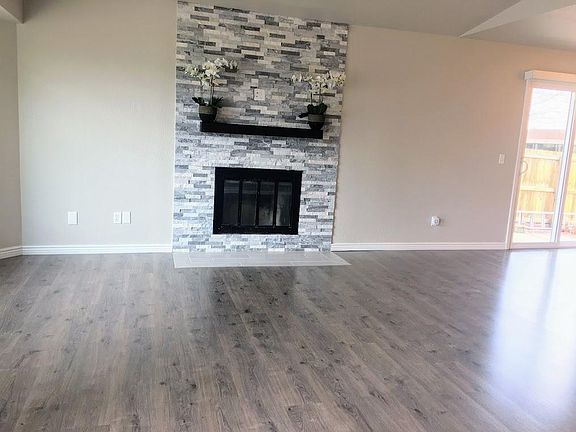 Spacious Great room w/New Stone Fireplace and Laminate Wood Flooring