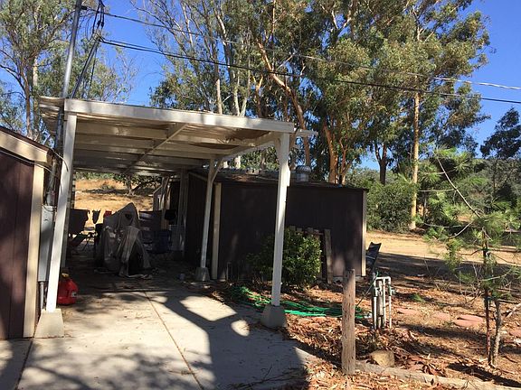 Patio beside home w/storage shed