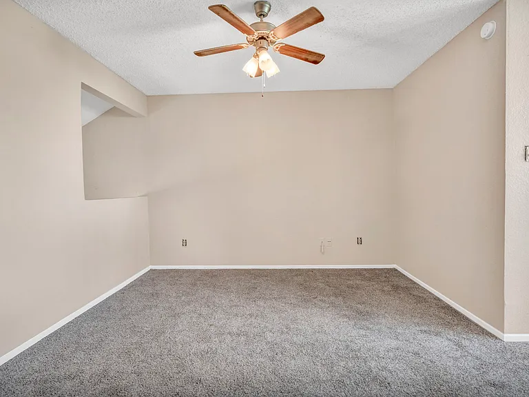Upstairs bedroom with ceiling fan boasting natural light in this amazing townhome.