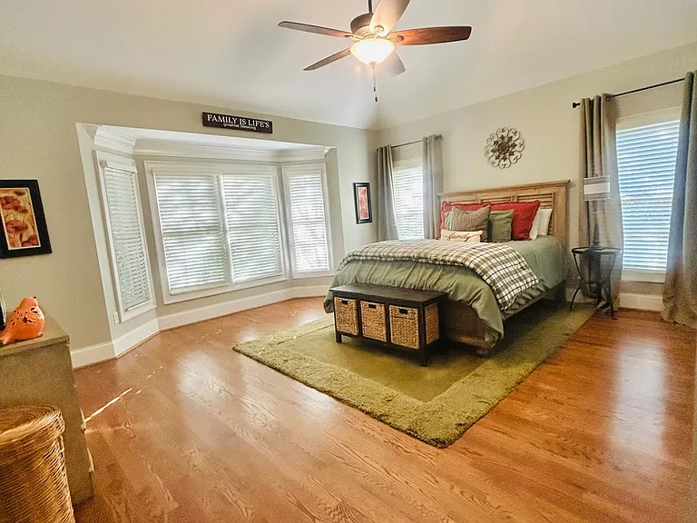 Huge primary bedroom with bay windows and oversized walk-in custom closet!