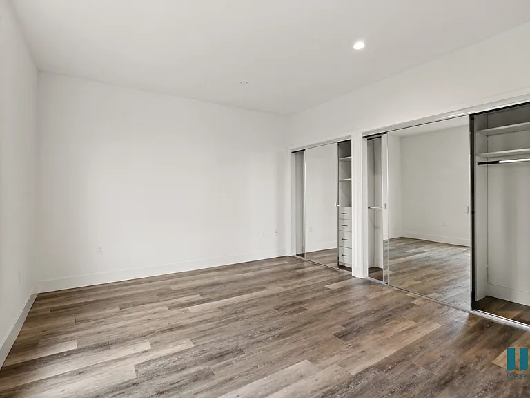 Bedroom with Two Mirrored Closets with Built-In Organizers
