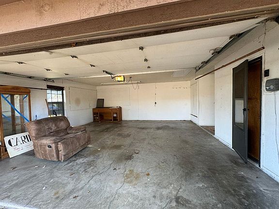 Oversized garage with work bench. Door thru utility room to Kitchen.