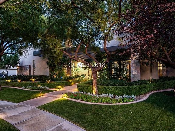 A largefour-car garage with epozy floors is discreetly tucked away from the front of the home.