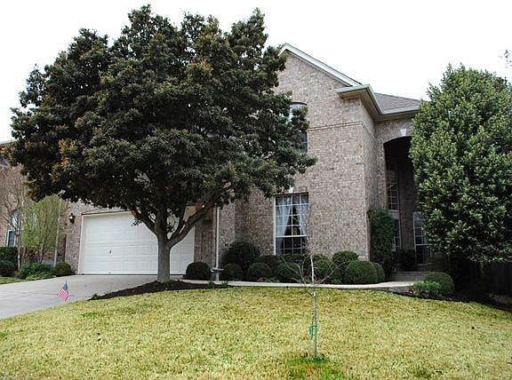 Nestled behind the large shade tree - this home is a true gem!