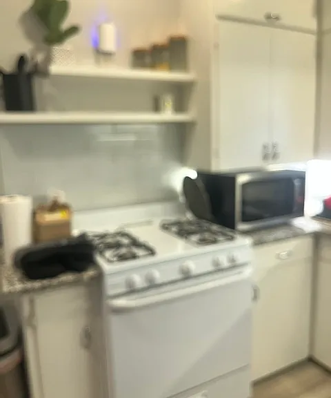 gas stove with open shelving & cabinets