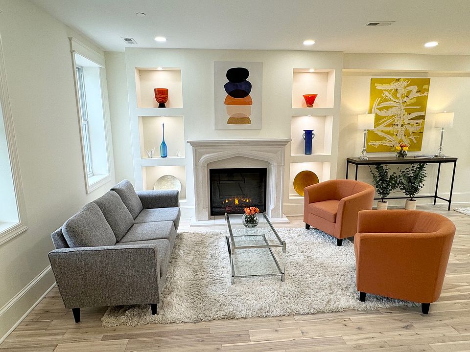 Living room with beautiful stone fireplace and realistic electric fireplace