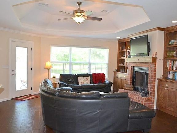 Living room has a custom octagonal tray ceiling and a nice view outdoors of the pool area.