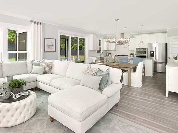 Large gathering room that looks over the dining and kitchen areas - Model Representation