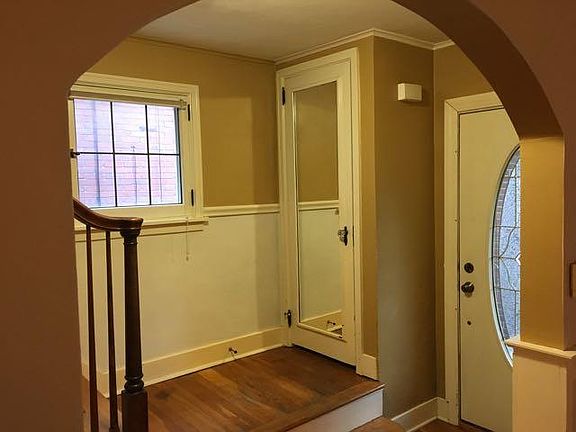 Arched doorways and hardwood floors.