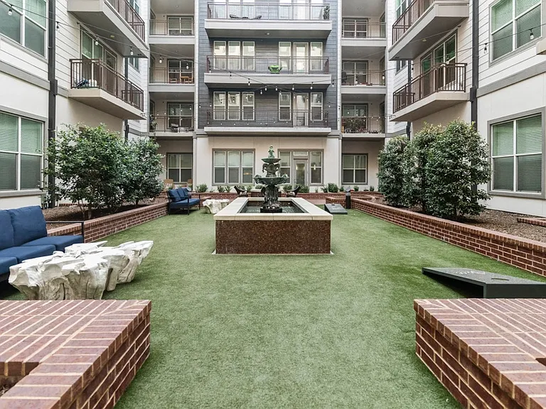 Our tranquil courtyard features a fire pit, historic water feature and lush landscaping