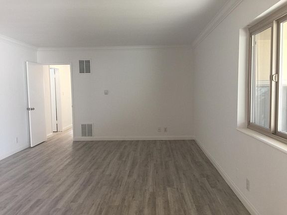 Amazing and huge living room with large ocean and garden view window and adjoins dining area with great big slider leading to yard that runs the length of the unit. Perfect open concept that is great for entertaining