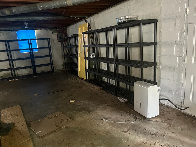 Large unfinished basement. Shelving stays. Dehumidifier stays, not replaced if it goes bad