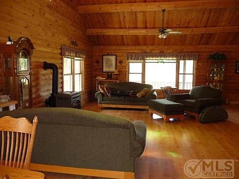 Full logs are great insulating factors.  Laminate flooring in the great room is easily maintained and fan/light fixtures are dotted throughout the home.