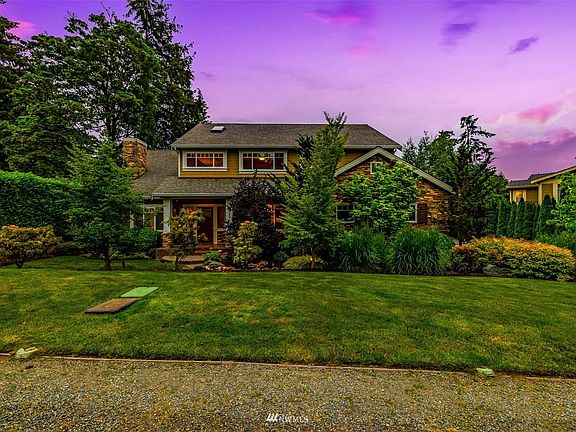 Set back off the cul de sac, the house is surrounded by lush, mature landscaping