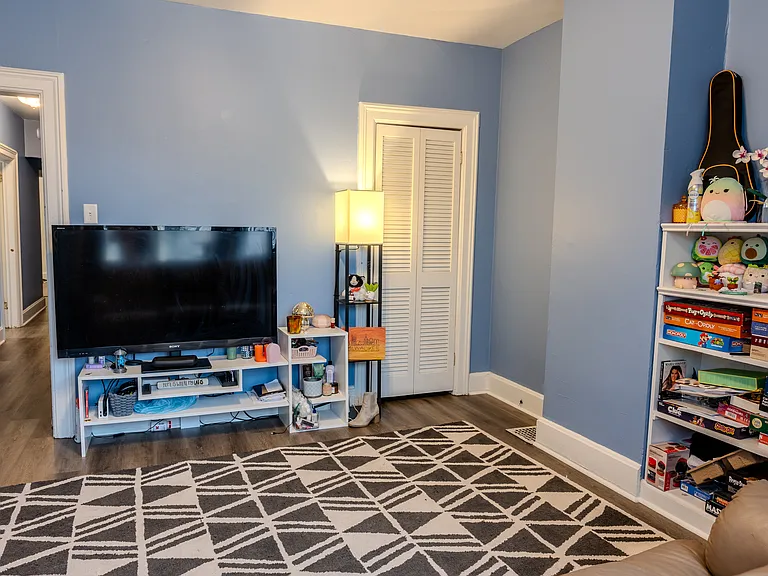 Enjoy this spacious living room with its built-in bookshelf and extra storage in the closet.