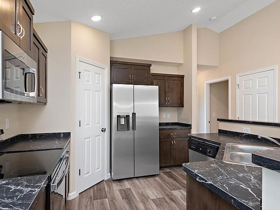 A full suite of appliances, including the refrigerator, brings style and efficiency to the