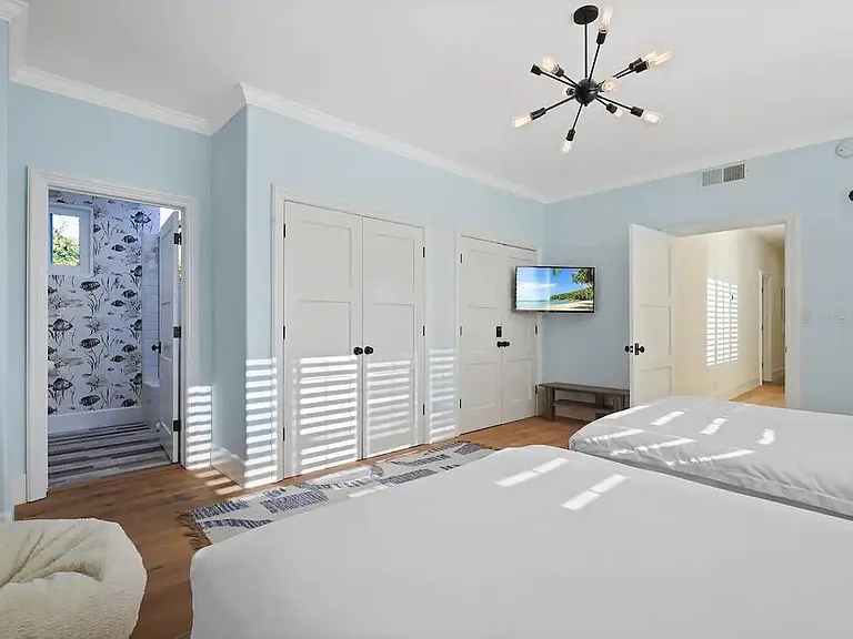 Guest bedroom with two twin beds and an en-suite bathroom space.