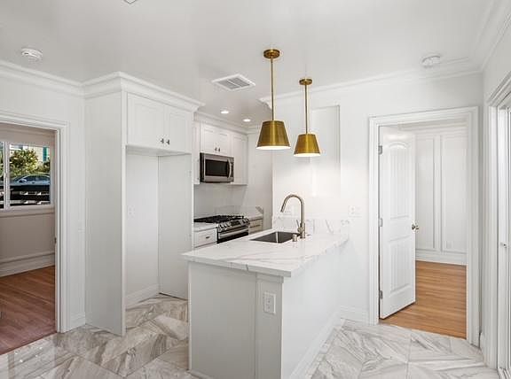 Beautiful Kitchen! En suite bedroom #1 entrance shown here to the left. En suite bedroom #2 entrance shown here to the right.