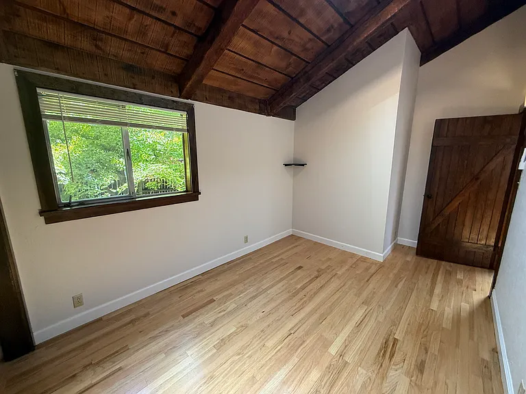 Bedroom #3 features wooden valuted ceiling, skylight, one window and 2 closets with a split AC cooling unit.