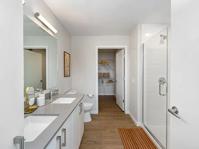 Finish Scheme I bath with grey countertops, white cabinetry, and hard surface flooring