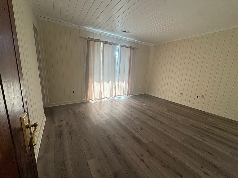 Bedroom with sliding door do private patio.